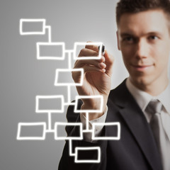 young businessman drawing diagram