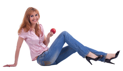 Fototapeta na wymiar tall mature woman in jeans sit with apple