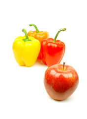 apple and yellow, red and green pepper on white