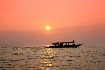 Sailing ship at sunset over the sea