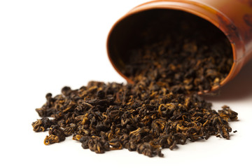 scattered raw black tea isolated on white
