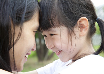 Fototapeta premium Beautiful little girl looking her mother