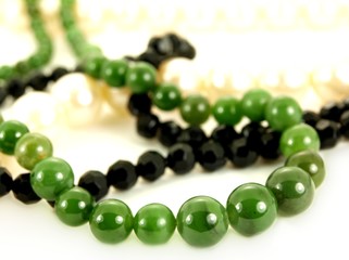 Green emerald gemstone, black and white pearls