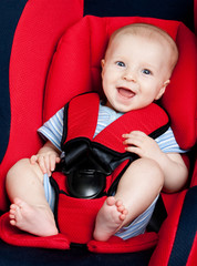 Happy boy in car seat