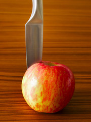 red apple with knife