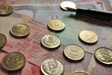 Indian Currency notes and Coins with fountain pen