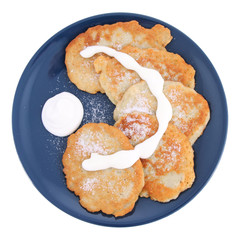 Potato pan cakes with cream and sugar on white background