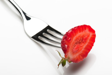 strawberry with fork on plate