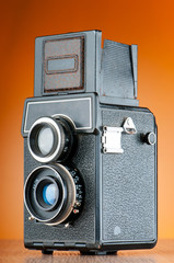 Vintage film camera against gradient background
