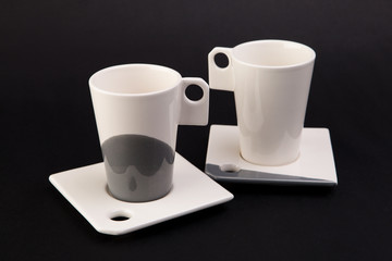 two cups on dark gray background