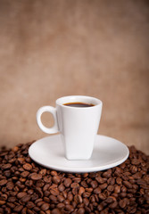 white cup and coffee beans