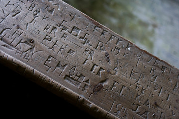 Carved names on pew in old church