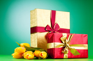 Celebration concept - gift box and tulip flowers