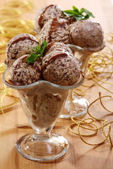 Peppermint ice cream with chocolate sauce and mint in a vertical