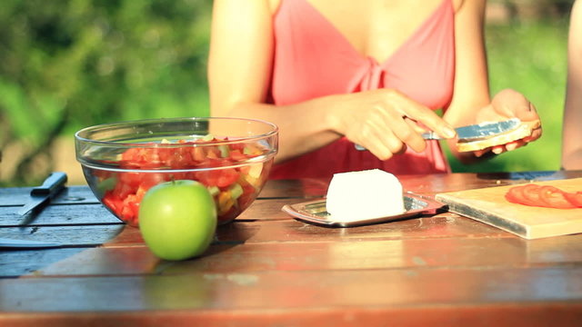 Mother with daughter preparing sandwich,  dolly shot