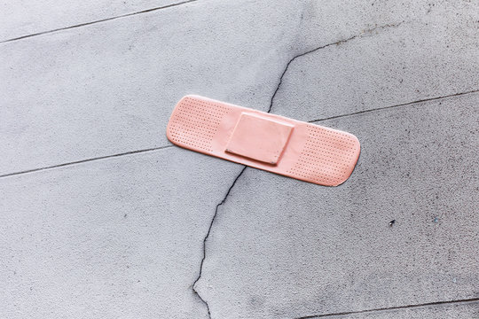 Plaster on a broken wall, symbolic