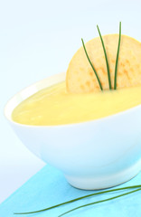 Fresh potato cream soup on bluish background