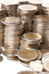 Close-up stacks of 2 Euros Coins in front of white background