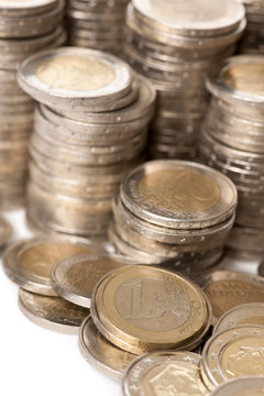 Close-up stacks of 2 Euros Coins in front of white background