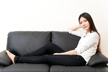 beautiful asian woman relaxing on the couch