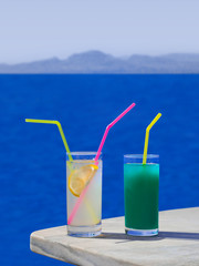 Two cocktails on table at beach
