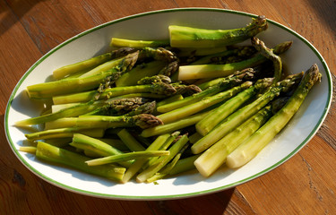 Boiled green asparagus in dish