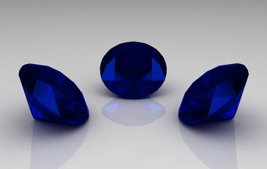 Trio of deep blue round sapphire stones