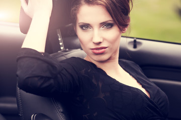 Fototapeta na wymiar Sexy woman in the car