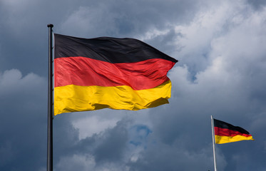 German flags in front of dark clouds