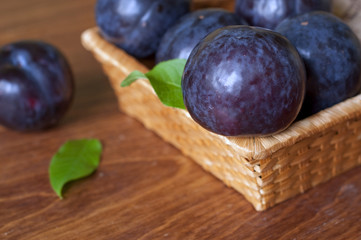 Plums in wicker basket