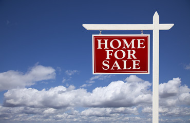 Red Home For Sale Real Estate Sign Over Clouds and Sky