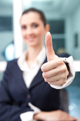 young businesswoman giving a thumbs up