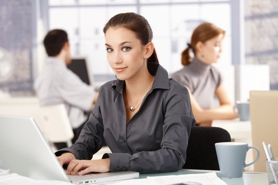Young female in office colleagues working behind