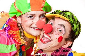 Two clown smiling isolated over a white background
