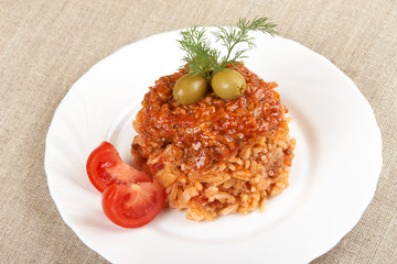 Risotto with meat, mushrooms and tomato sauce