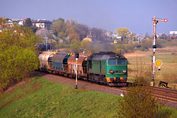 Obraz premium Freight train passing the hilly landscape