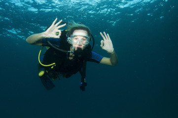 scuba diver makes OK sign