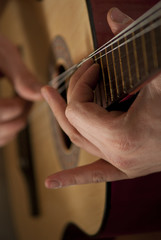 The musician plays a guitar