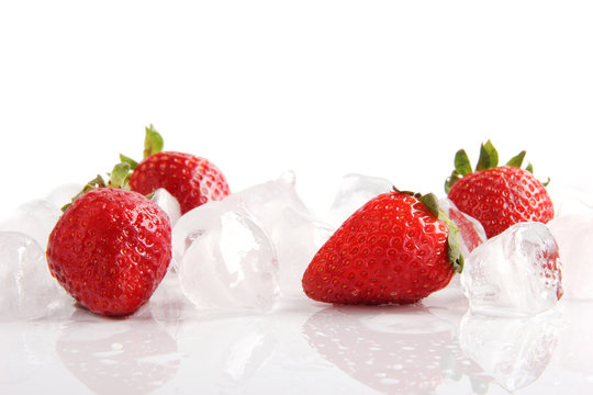 Strawberries with ice cubes, isolated on white background