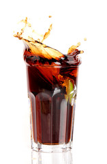 Glass of cola splashing, isolated on white background