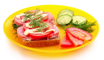 tomatoes, cucumber and sausage on bread isolated on white