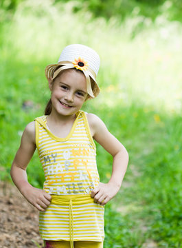 Happy little girl blowing dandelion