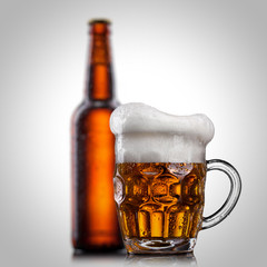 Beer in glass with water drops isolated on white