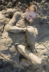 Beautiful girl struggling in the mud