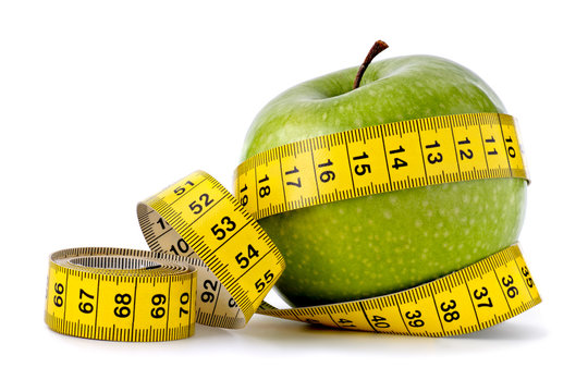 Green apple with measuring tape on white background