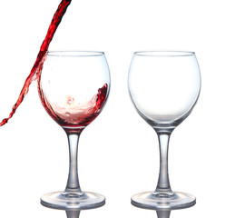 red wine pouring into glass isolated on white