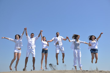 Fototapeta premium happy people group have fun and running on beach
