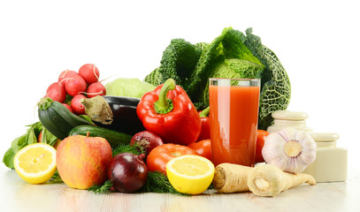 Composition with raw vegetables and glass of juice isolated on w
