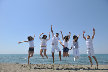 happy people group have fun and running on beach
