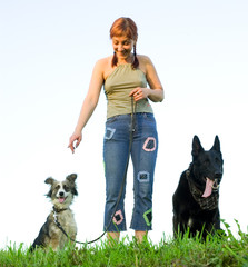 woman with her dog on meadow